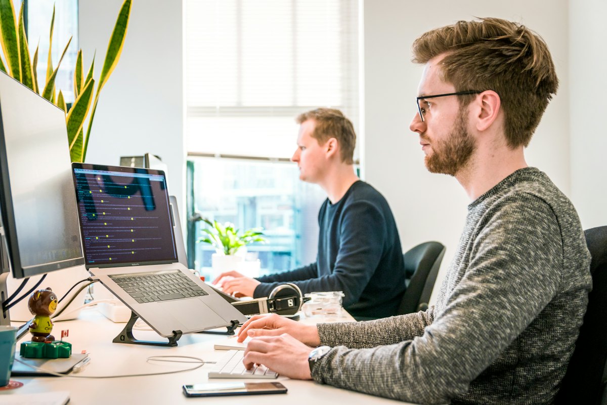 Developers collaborating at a workstation.